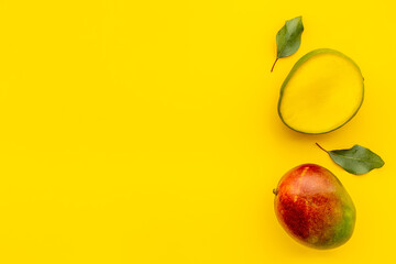 Mango fruits and slices. Tropical fruits background