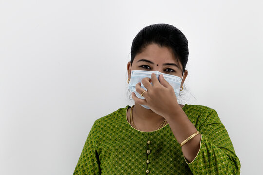 Beautiful Smiling Indian Young Woman In Protective Face Mask Not Wearing Properly And Saying Wear Proper,  Healthcare Concept, Isolated Over White Background