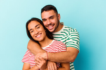 Young mixed race couple isolated on blue background