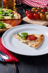 Brazilian-style pizza with mozzarella, sun-dried tomatoes and arugula.