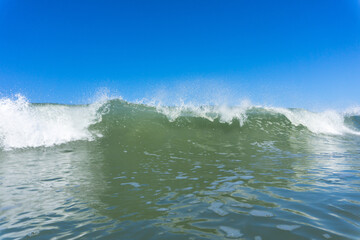 Small summer wave with blue sky