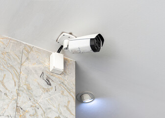 CCTV security camera on white ceiling