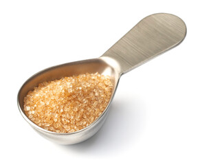 yellow sugar in the metal measuring spoon, isolated on white background