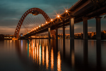 Evening lights on a picturesque bridge, reflected in the Moscow river.