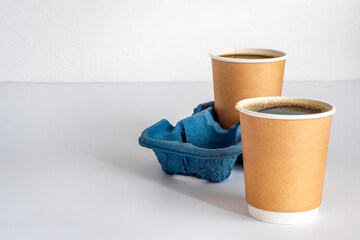 Take out coffee in paper cups on the table. Close up