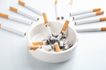 White ashtray with a cigarette. Smoking