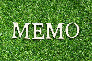 Alphabet letter in word memo on green grass background