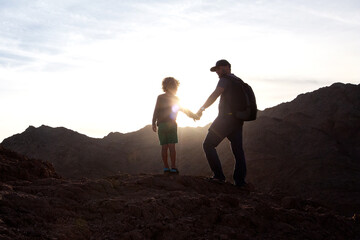 Dad with son in the mountains in the desert