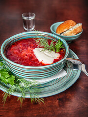 Traditional beetroot soup borscht with green parsley .
