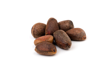 Fresh unpeeled cedar nuts isolated on white background, closeup