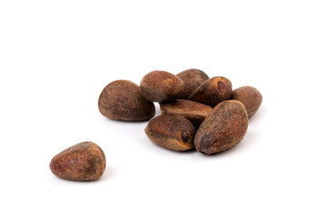 Fresh unpeeled cedar nuts isolated on white background, closeup