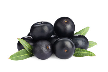 Pile of fresh ripe acai berries and green leaves on white background