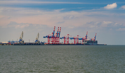 Jade Weser Port with a large container ship on the coast of Wilhelmshaven, Lower Saxony
