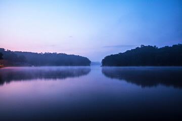 The natural scenery of the lake where the water mist bloomed on a summer morning