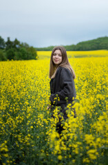 Young girl on yellow rapeseed field