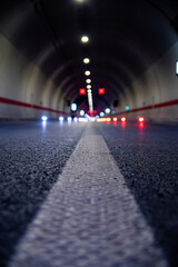 Selective focus shot of illuminated highway road tunnel