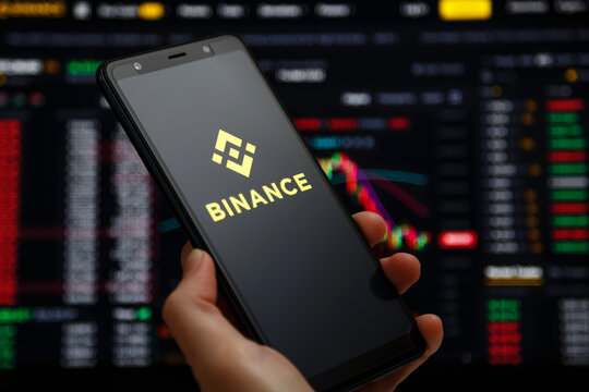 Ukraine, Odessa - June, 1 2021: Binance mobile app running at smartphone screen with a trading page at background. Binance one of the world's leading cryptocurrency exchange and trading platform