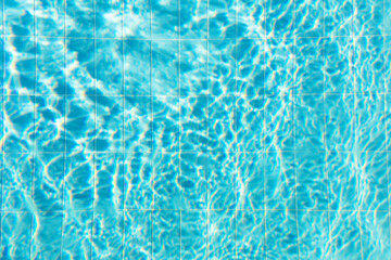 Blue ripped water with waves and rays in the swimming pool Summer vacation Background. Top view Copy space.