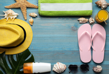 Frame of different beach objects on turquoise wooden background, flat lay. Space for text