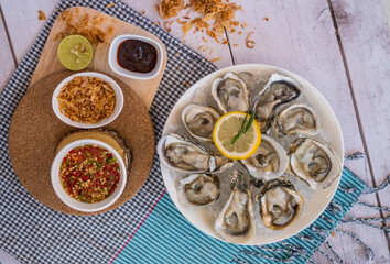 Oyster and side dishes in Thai style with spicy dipping sauce.