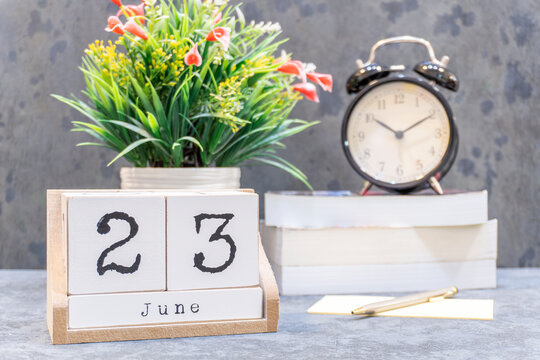 June 23rd. June 23 wooden cube calendar with blur objects on background.