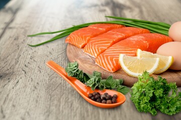 Fresh raw salmon fillet with greens and spices.