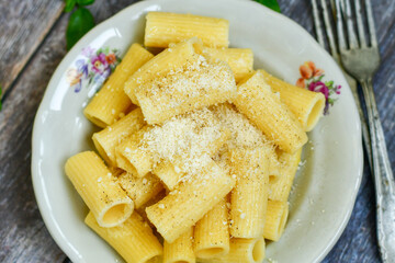  Home made  italian rigatoni   pasta  with parmesan cheese,garlic  and black pepper .Pasta cacio e pepe. Mediterranean food concept