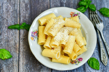  Home made  italian rigatoni   pasta  with parmesan cheese,garlic  and black pepper .Pasta cacio e pepe. Mediterranean food concept