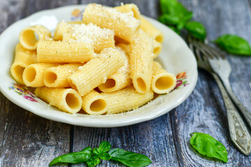  Home made  italian rigatoni   pasta  with parmesan cheese,garlic  and black pepper .Pasta cacio e pepe. Mediterranean food concept