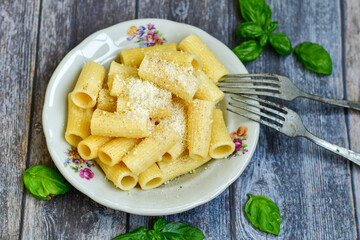  Home made  italian rigatoni   pasta  with parmesan cheese,garlic  and black pepper .Pasta cacio e pepe. Mediterranean food concept
