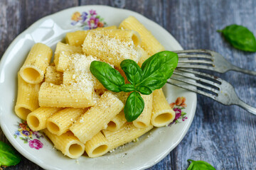  Home made  italian rigatoni   pasta  with parmesan cheese,garlic  and black pepper .Pasta cacio e pepe. Mediterranean food concept