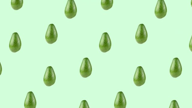 pattern with many whole avocados rotating close-up on a green background. seamless looping animation with copy space