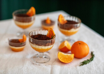 Homemade tiramisu with tangerines on a table