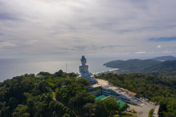 aerial photography Phuket big Buddha in sunny day.Phuket Big Buddha is one of the most important and revered landmarks on Phuket island..white cloud in blue sky, blue sea and mountain background