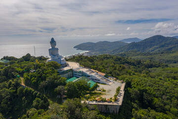 aerial photography Phuket big Buddha in sunny day.Phuket Big Buddha is one of the most important and revered landmarks on Phuket island..white cloud in blue sky, blue sea and mountain background © Narong Niemhom