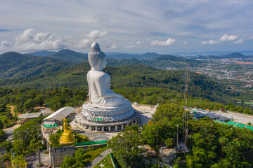 aerial photography Phuket big Buddha in sunny day.Phuket Big Buddha is one of the most important and revered landmarks on Phuket island..white cloud in blue sky, blue sea and mountain background © Narong Niemhom