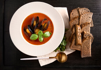 Traditional mussels tomato soup bouillabaisse. Seafood background .