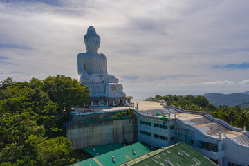aerial photography Phuket big Buddha in sunny day.Phuket Big Buddha is one of the most important and revered landmarks on Phuket island..white cloud in blue sky, blue sea and mountain background © Narong Niemhom