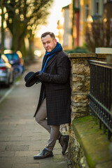 English style. A man walking through the streets of the city. Evening walk. Portraits of people.