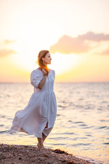 Fototapeta na wymiar Beautiful woman relaxes by the sea