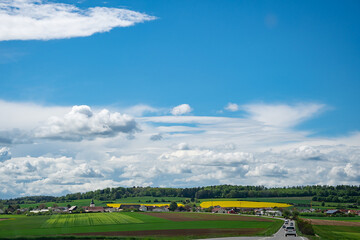 Obraz premium rapeseed field in bavaria, beautiful clouds on a summer day