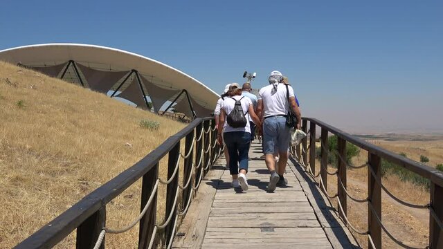 Gobeklitepe, Sanliurfa, Turkey - 15th of June 2021: 4K Tourists approaches Gobekli Tepe archaeological site
