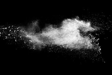 Naklejka premium White dust particles splashing. Freez motion of talcum powder burst in dark background.