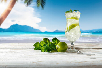 Summer drink on the table and nice landscape in the background 