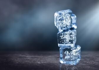 Crystal clear natural ice block on a dark surface.