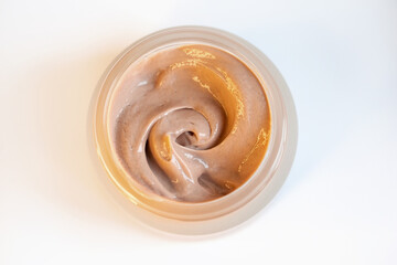 Cream in a jar on a white background