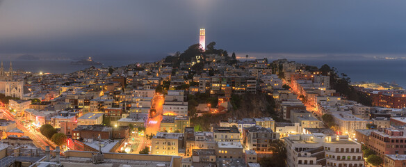 Coit Tower lit in pink for San Francisco LGBT Pride, with foggy skies over Telegraph Hill and North...