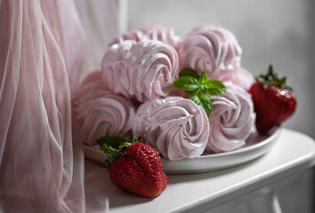 Homemade pink strawberry zephyr or marshmallow on a wooden table. Selective focus.