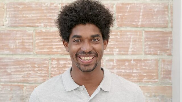 Portrait of a smiling young afro man looking at camera