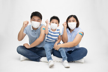 Asian family wearing white face mask and showing arm with plaster of covid-19 vaccinated isolated on white background, Adhesive bandage on arm after injection of vaccine concept